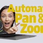 Person smiling and pointing at text that reads "Automatic Pan & Zoom!" on a gray background. A laptop displays a graphic of zoom functions, showcasing FocuSee review for top screen recording software.